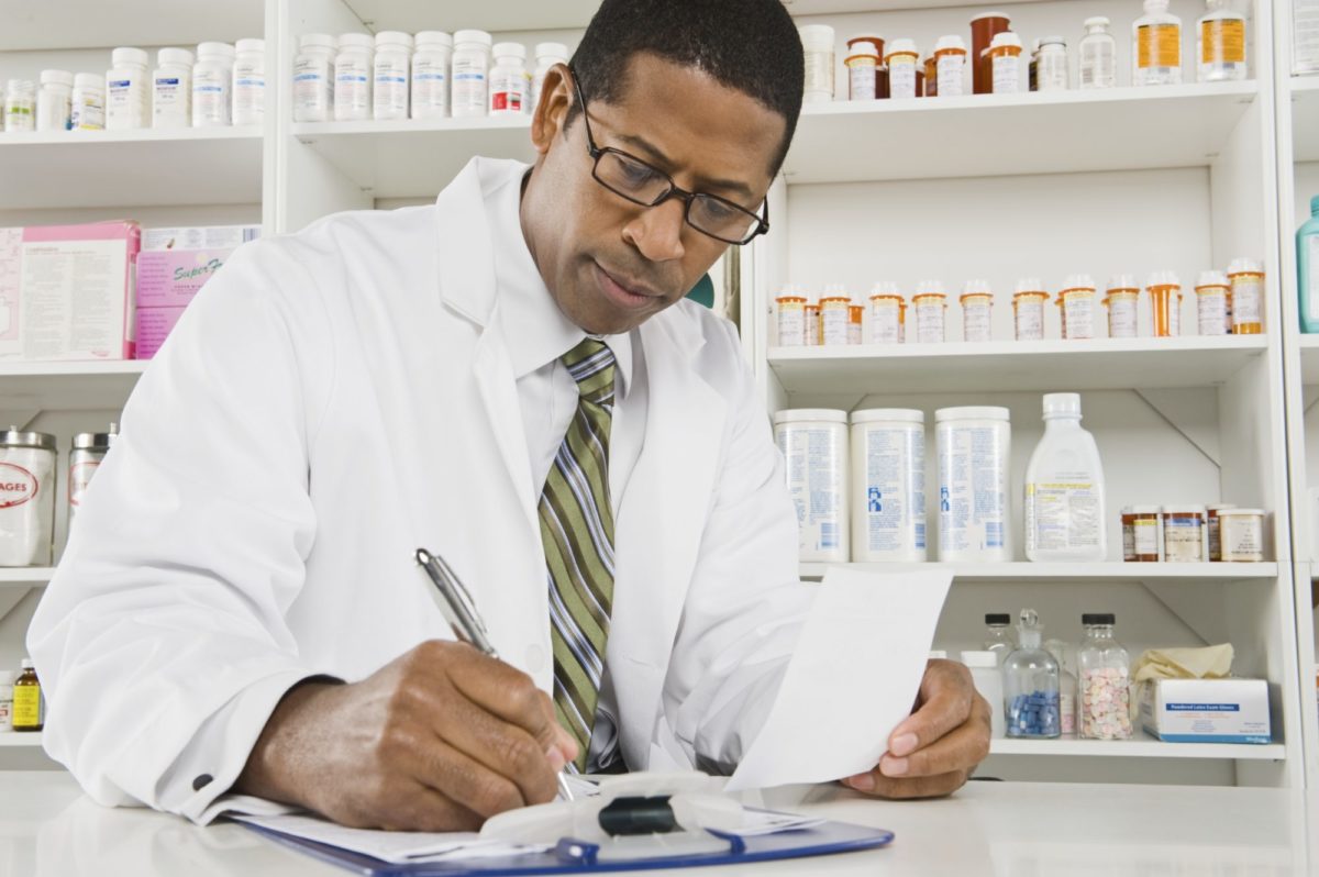 pharmacist writing on clipboard