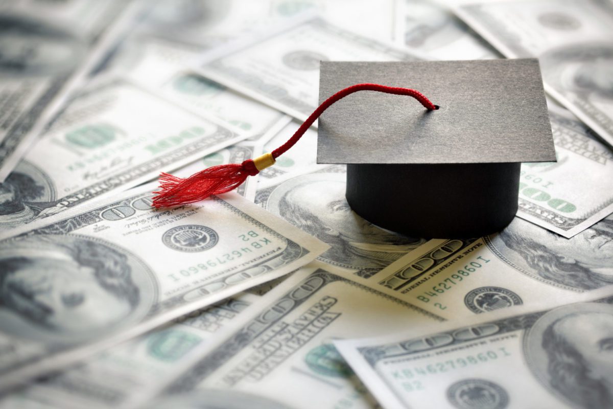 graduation cap on $100 bills
