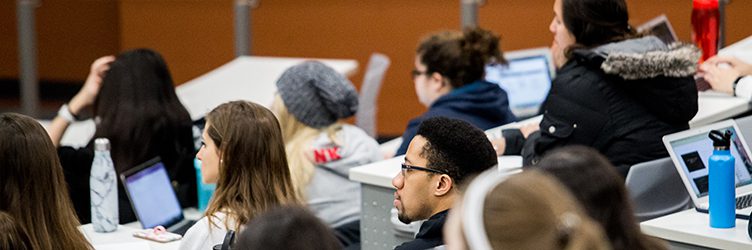 Students in a lecture hall listen to a professor on the UW-Madison campus.