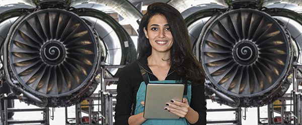 Young female engineer using digital tablet for airplane mechanics