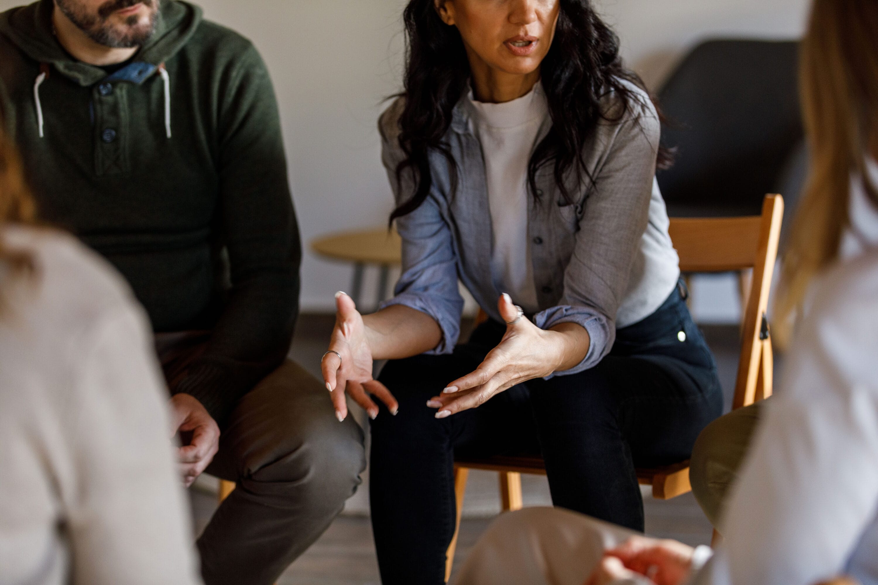 A shot of a woman and a man sitting next to each other during a group discussion in class
