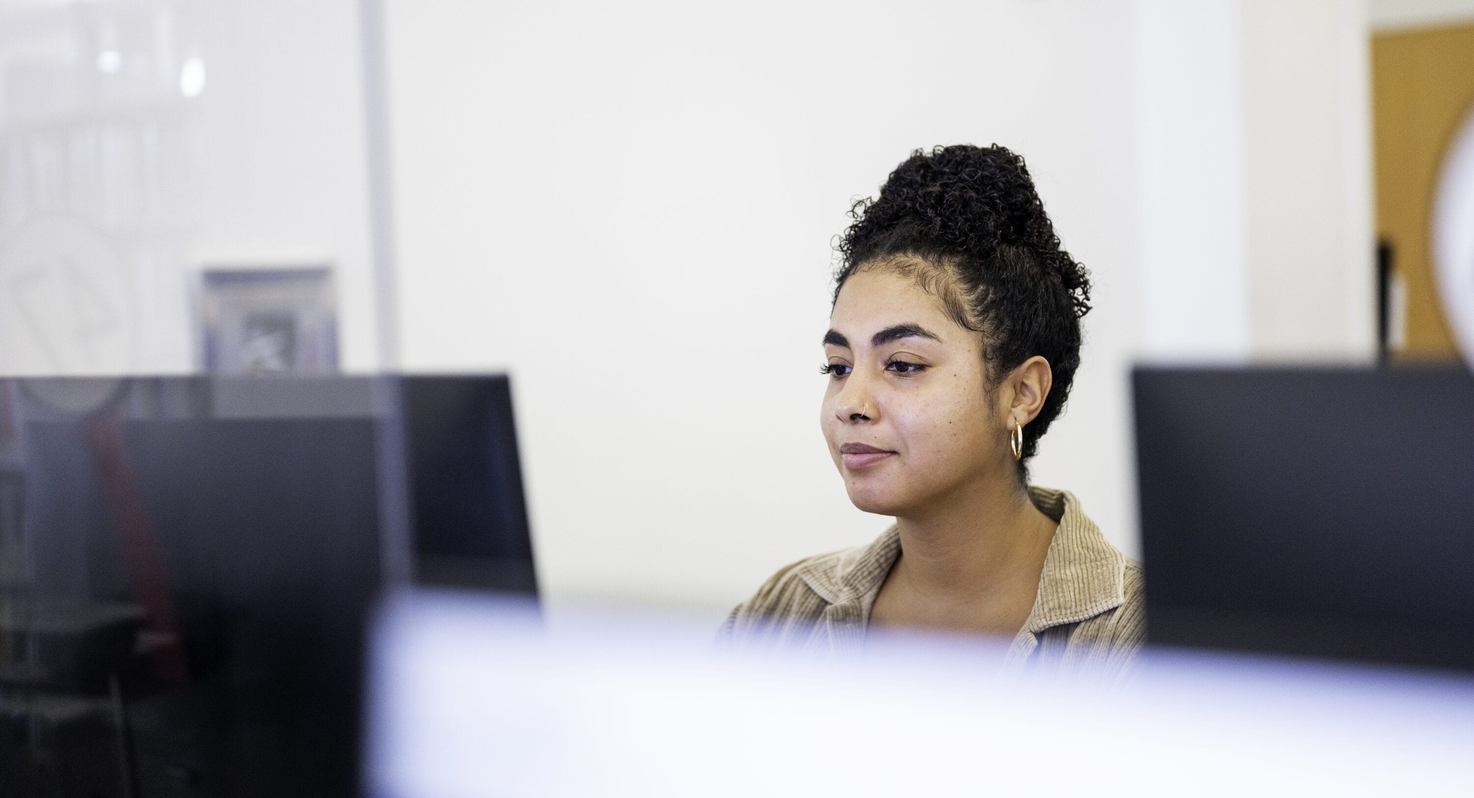 A woman working on a desktop computer.