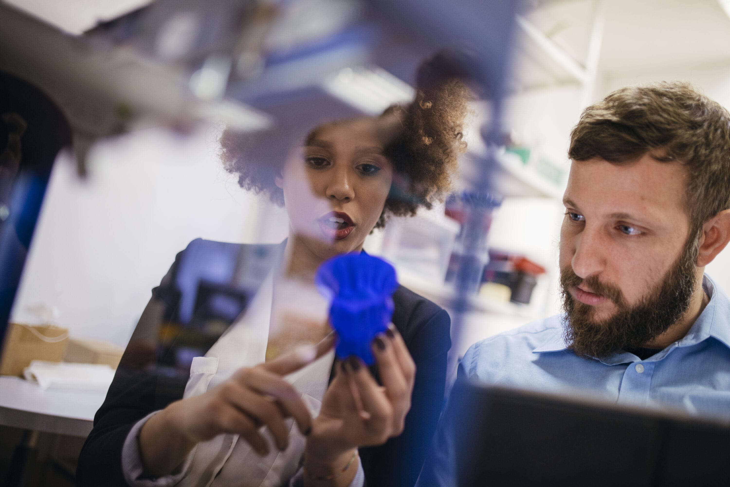 Two working professionals reviewing testing equipment.