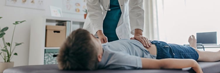 A doctor conducting a physical exam of a child
