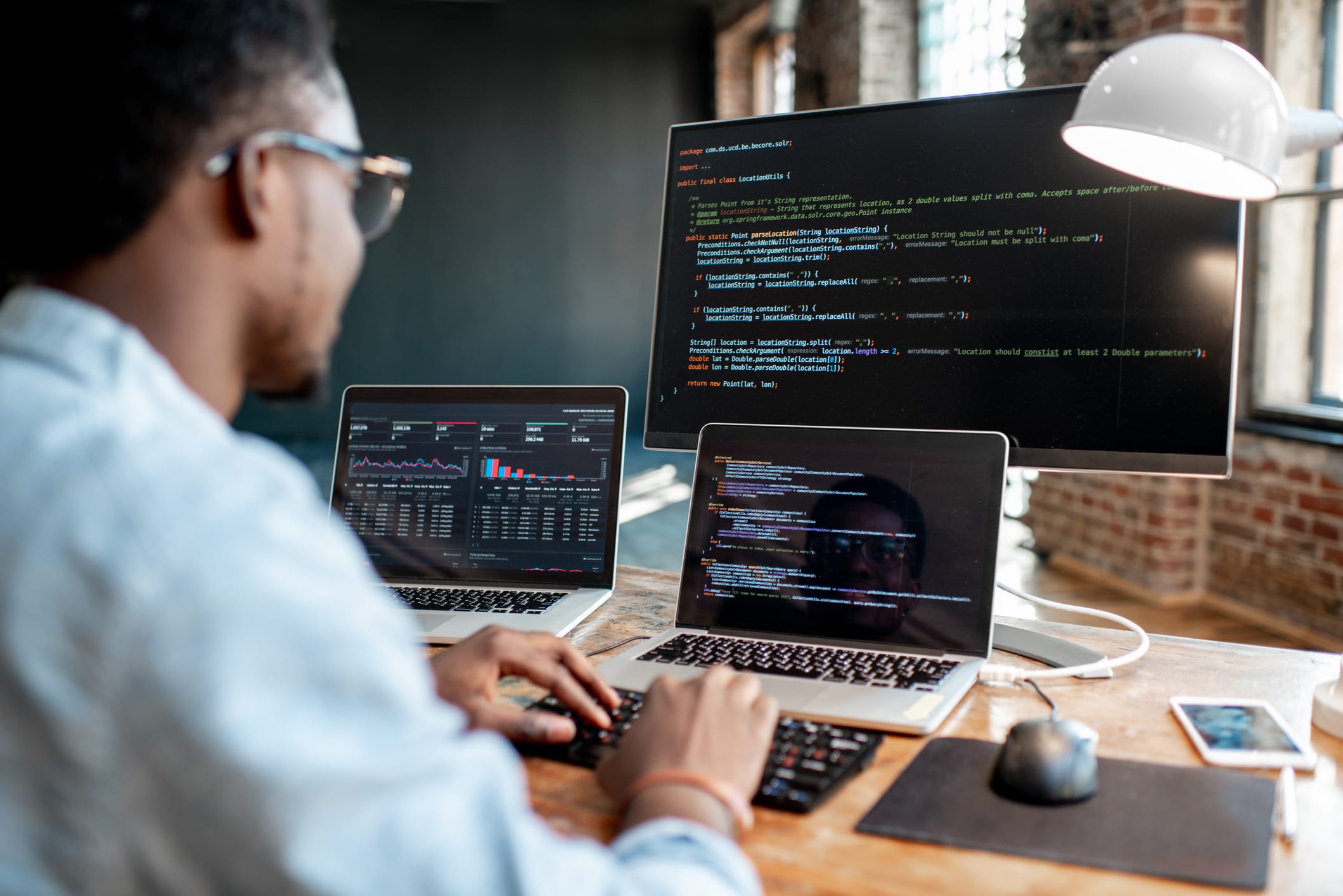 Man coding on his work desktop