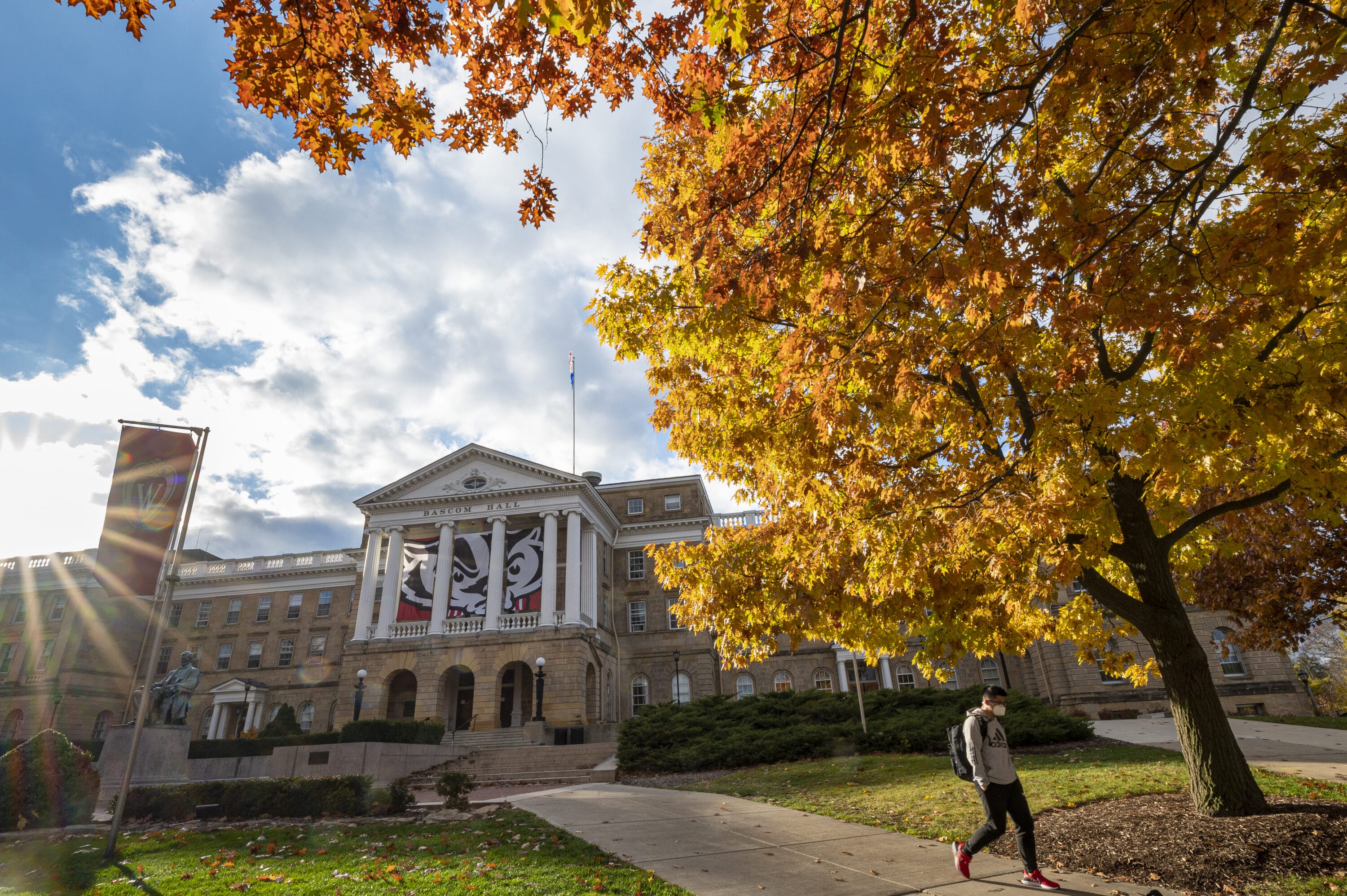 A student walking away from Bascom Hall.