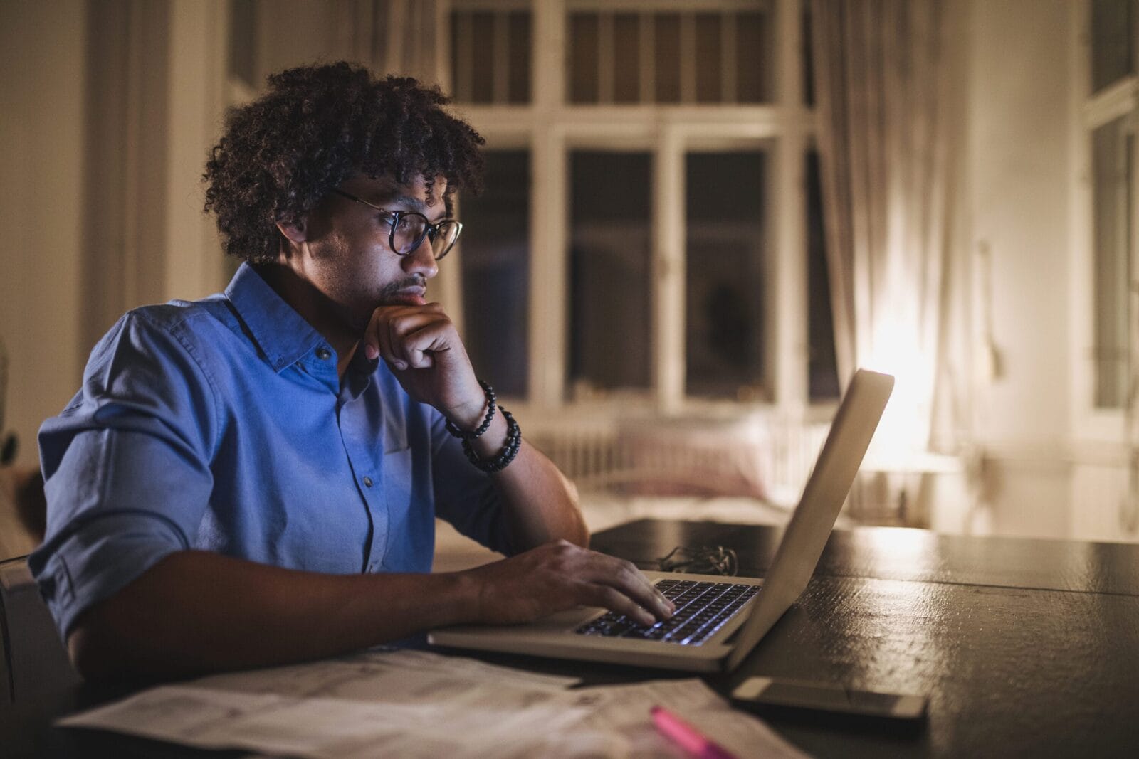 A man on his laptop in his home.