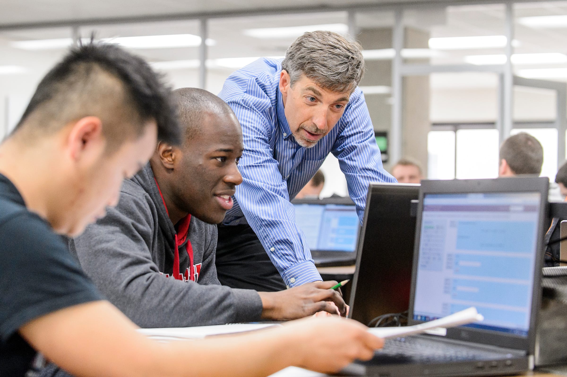 Professor Barry Van Veen helping his students with their work.