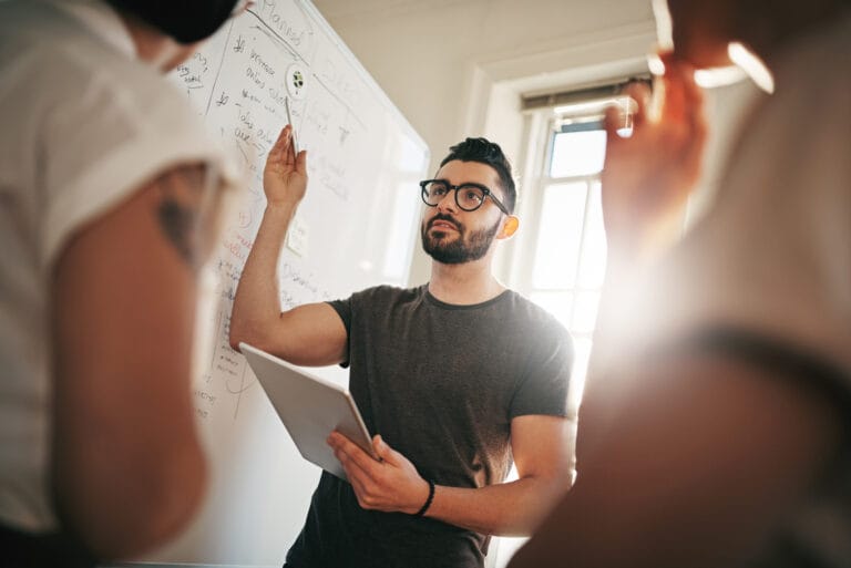 A business man giving a presentation to his team.