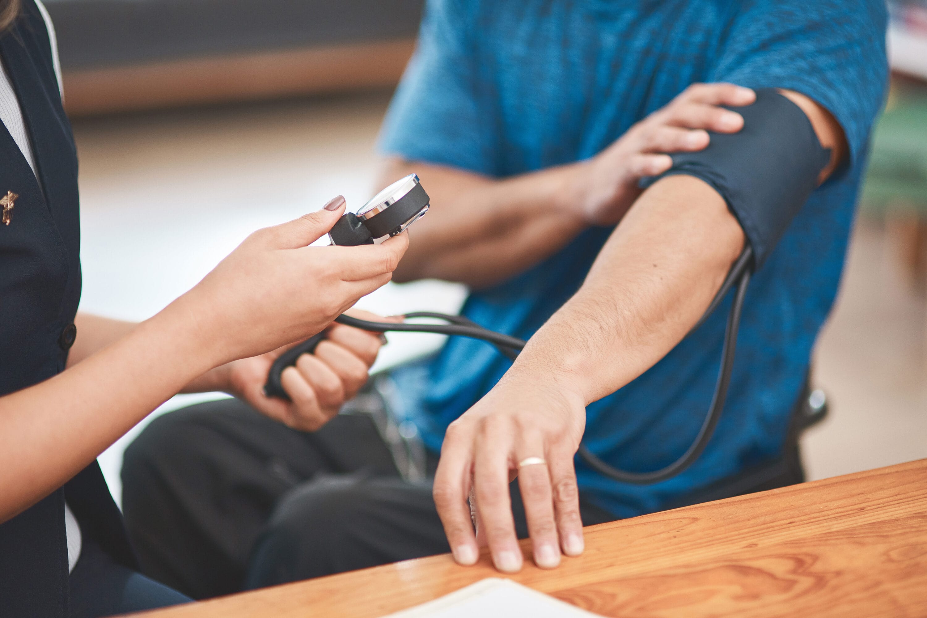 A medical professional taking a patient's pressure.