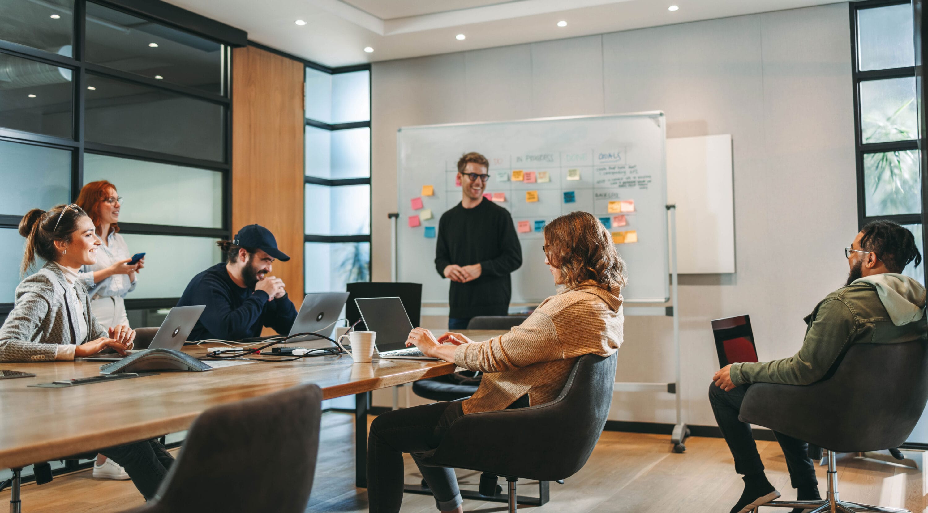 A group of people speaking amongst themselves in a conference room.