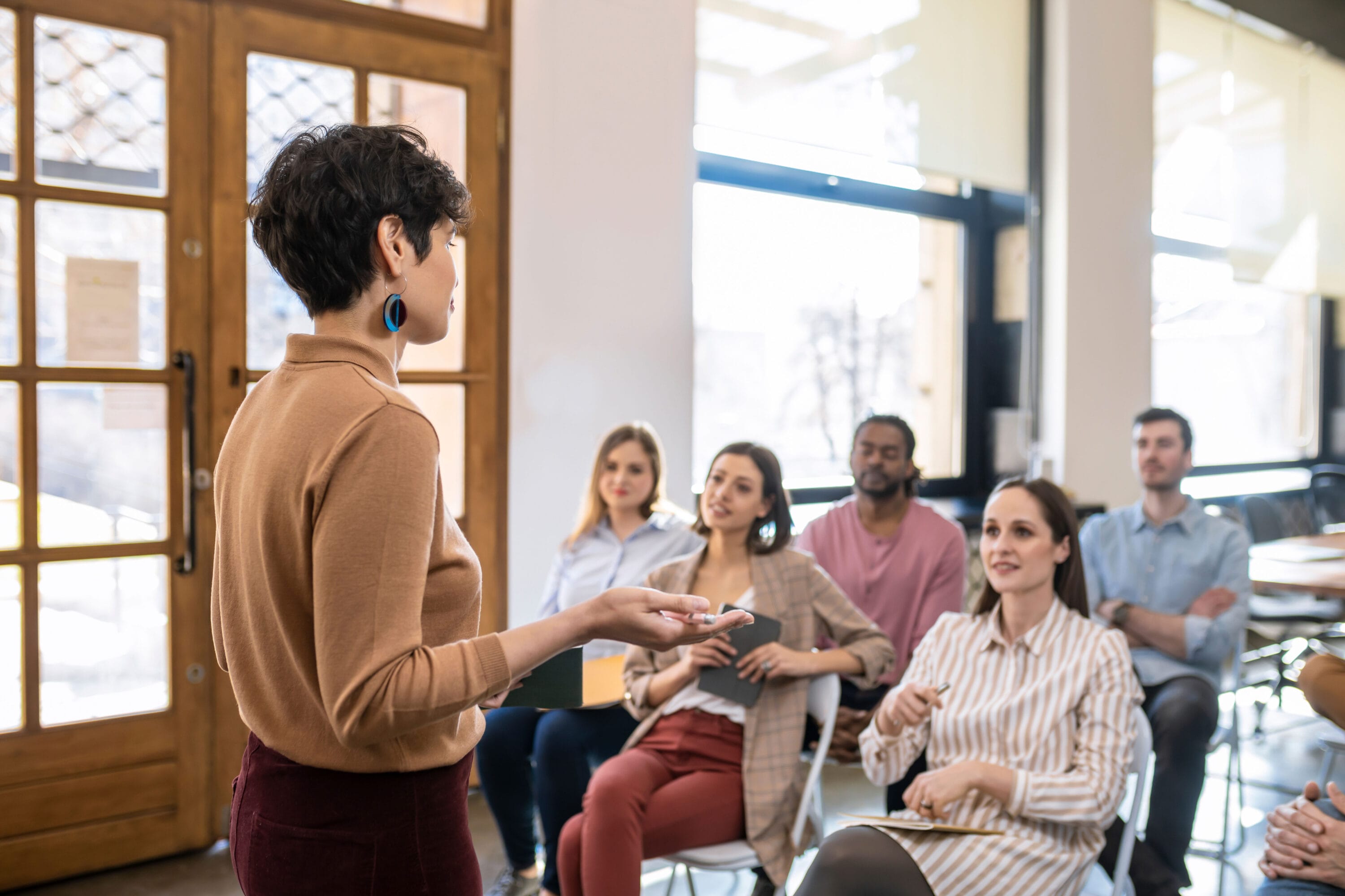 A woman giving a presentation to a group of people.