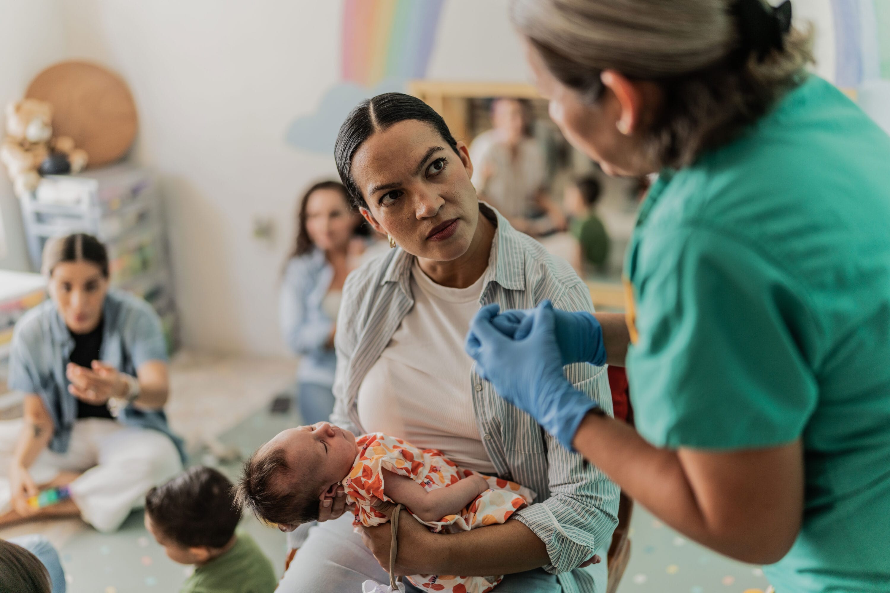 A nurse teaching the mother how to care for her child.