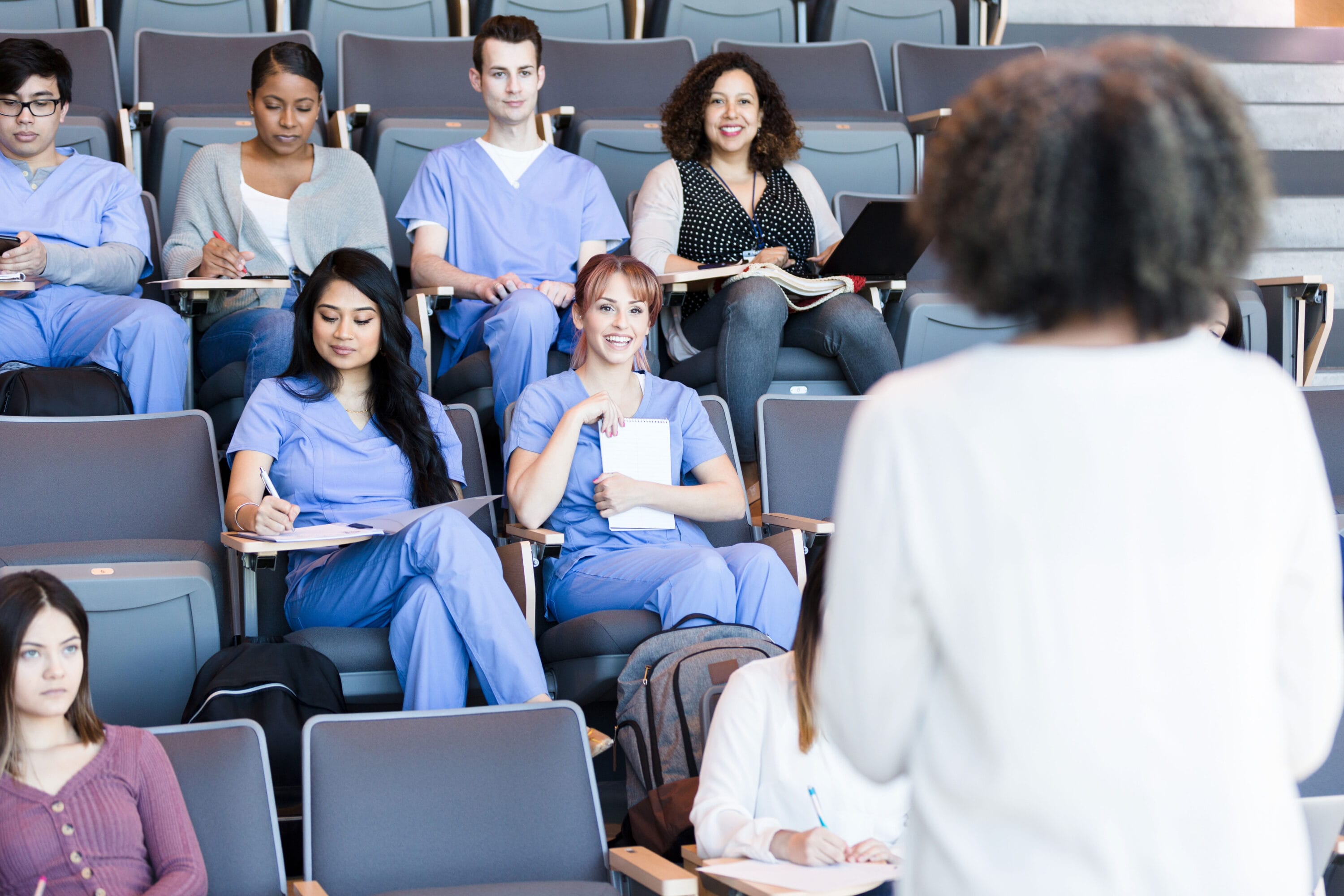 A group of nursing students listening to a lecture.