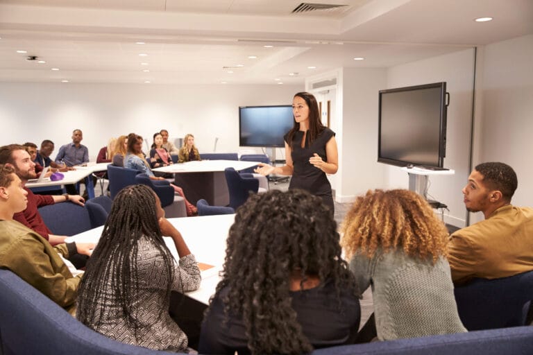 Teachers holding a meeting in a room.