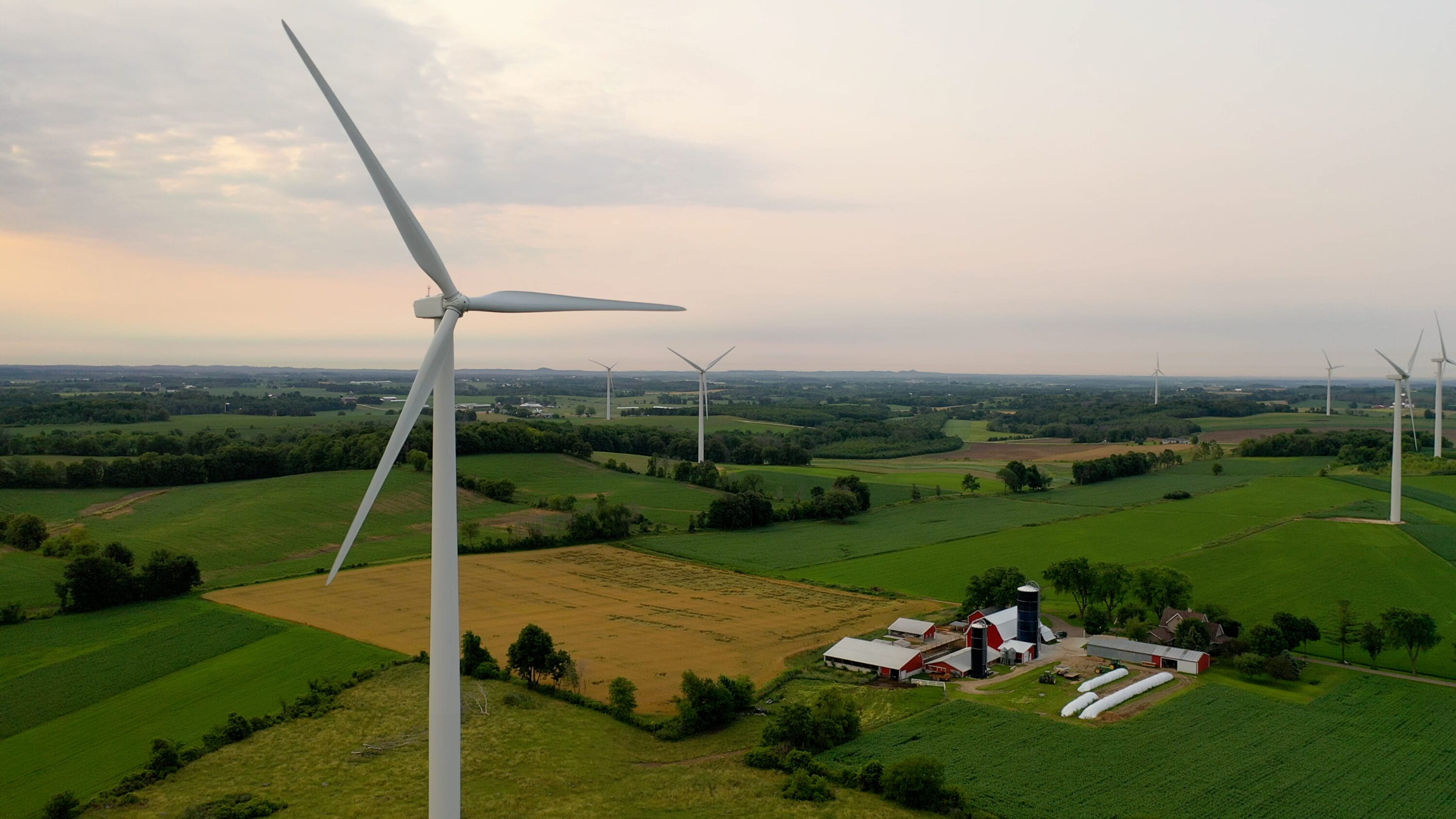 Aerial view of a windmill over a farm.